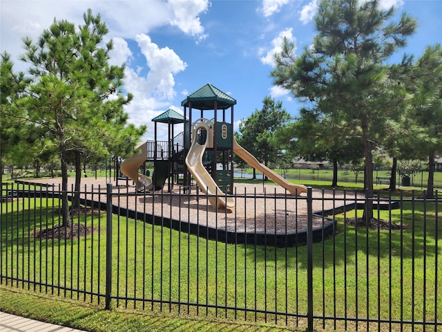 community playground with a lawn and fence