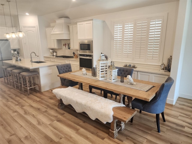 dining space featuring recessed lighting and light wood finished floors