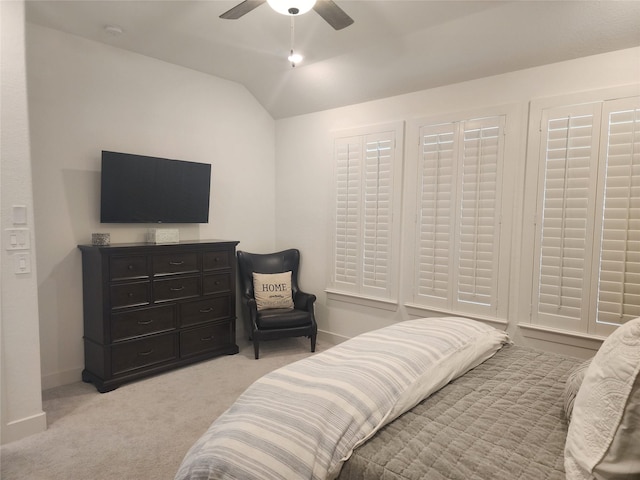 bedroom with baseboards, a ceiling fan, vaulted ceiling, and light carpet