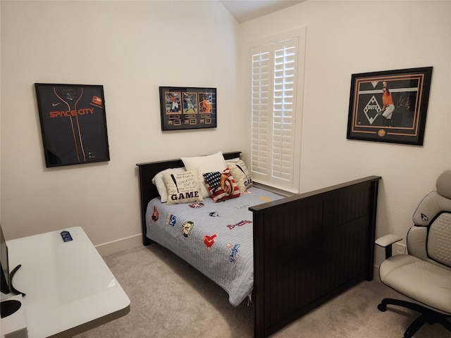 bedroom with carpet floors and baseboards