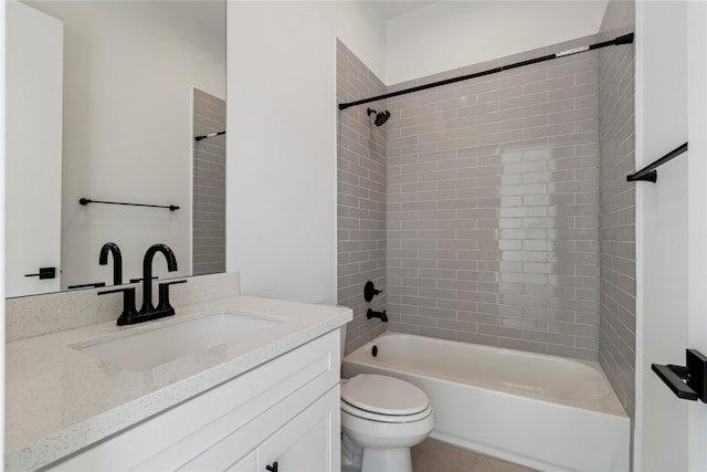 full bathroom with tile patterned flooring, vanity, toilet, and tiled shower / bath