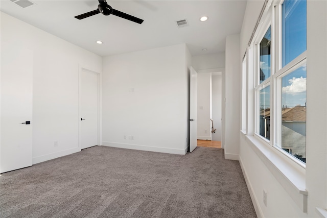 unfurnished room with light carpet and ceiling fan