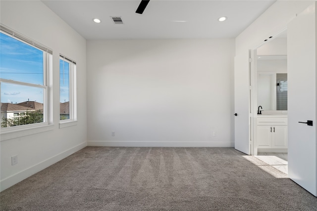 unfurnished room with light colored carpet