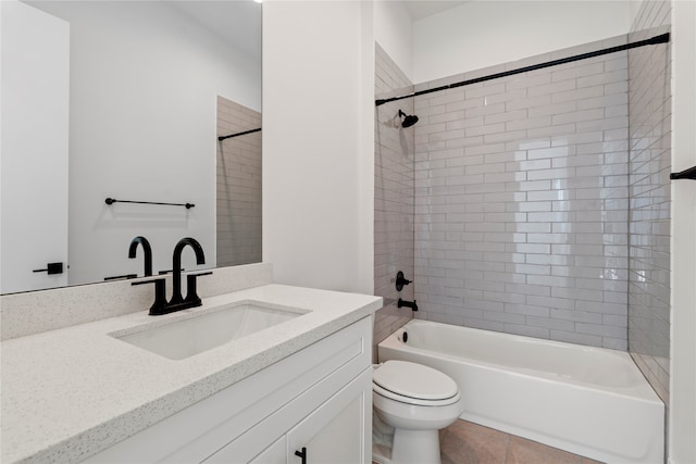 full bathroom featuring tile patterned floors, tiled shower / bath combo, toilet, and vanity