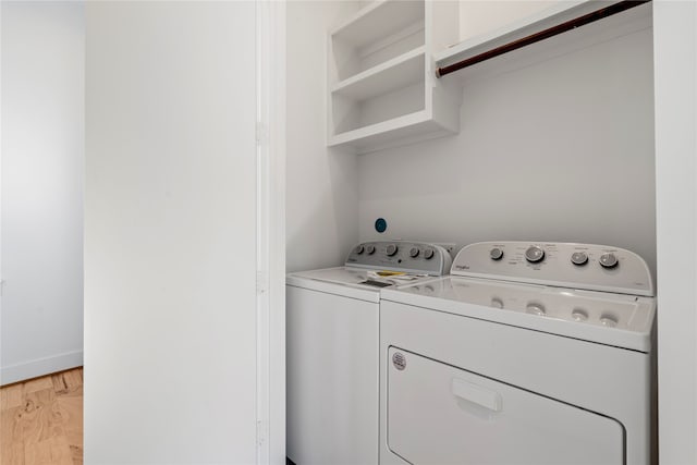 laundry area featuring washer and dryer and light wood-type flooring