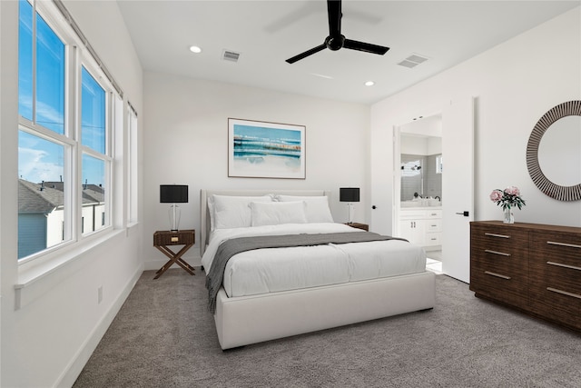 bedroom featuring carpet floors, ensuite bathroom, and ceiling fan