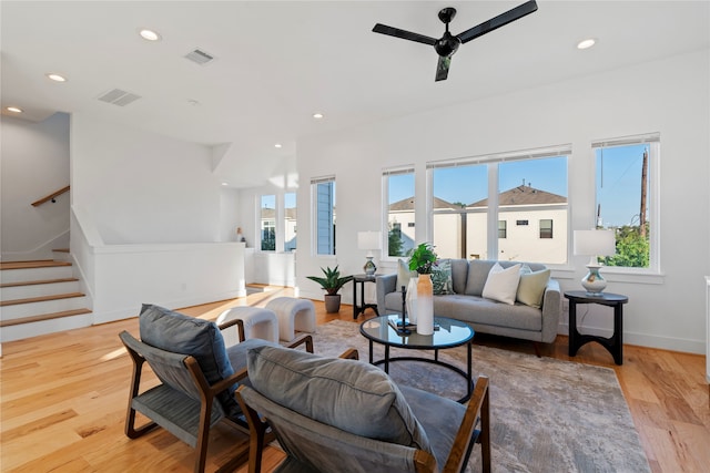 living room with light hardwood / wood-style floors and ceiling fan