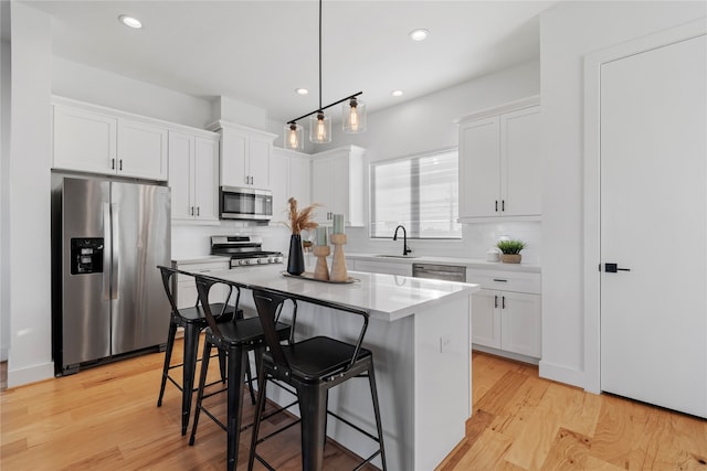 kitchen with white cabinetry, a center island, and stainless steel appliances