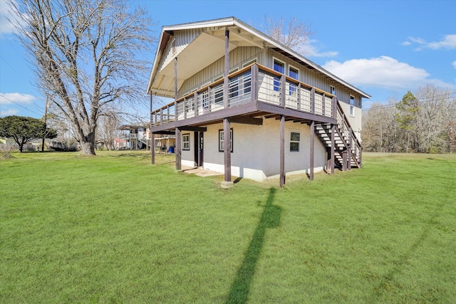 rear view of property featuring a lawn