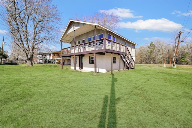 rear view of property with a yard and a deck