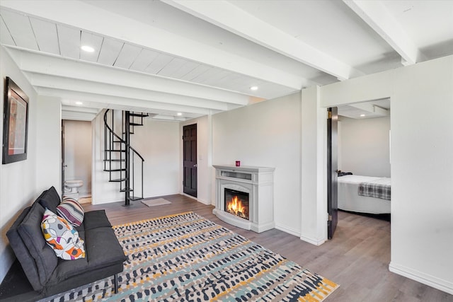 living room featuring hardwood / wood-style floors and beamed ceiling