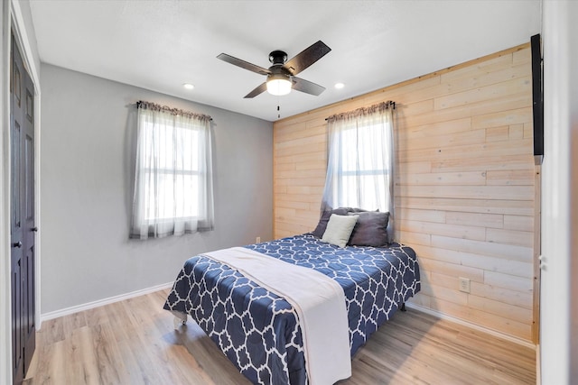 bedroom with ceiling fan, a closet, light wood-type flooring, and multiple windows