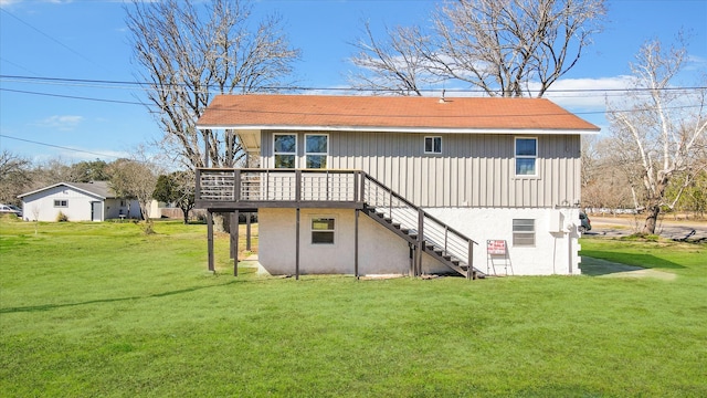 back of house with a yard and a deck