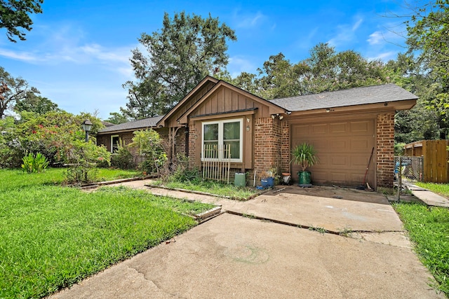 ranch-style house featuring a front yard and a garage