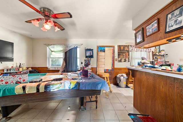 bedroom with ceiling fan and light tile patterned floors