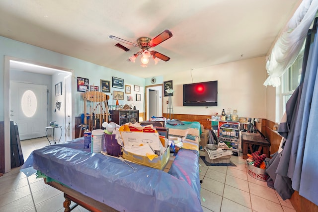 rec room featuring light tile patterned floors and ceiling fan