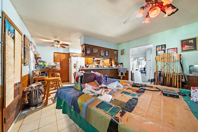 tiled bedroom with ceiling fan and white refrigerator with ice dispenser