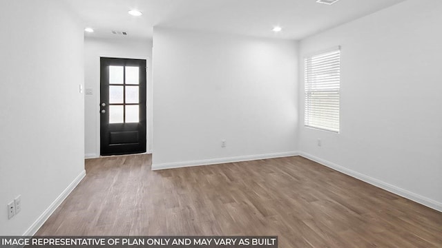 spare room featuring hardwood / wood-style flooring and a wealth of natural light