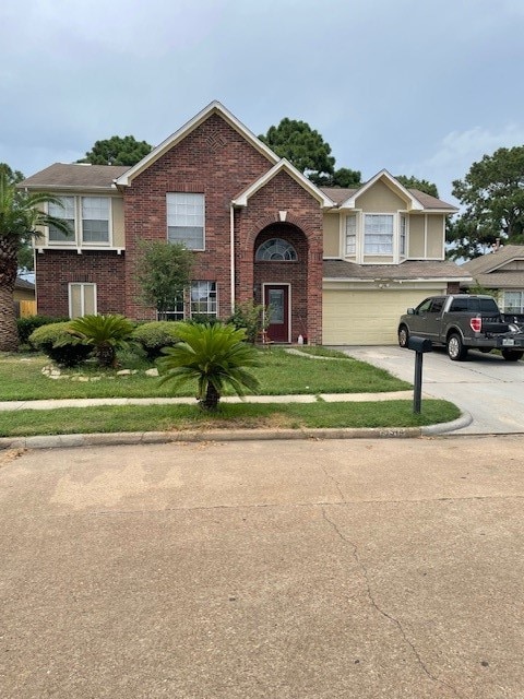 bi-level home featuring a garage and a front lawn