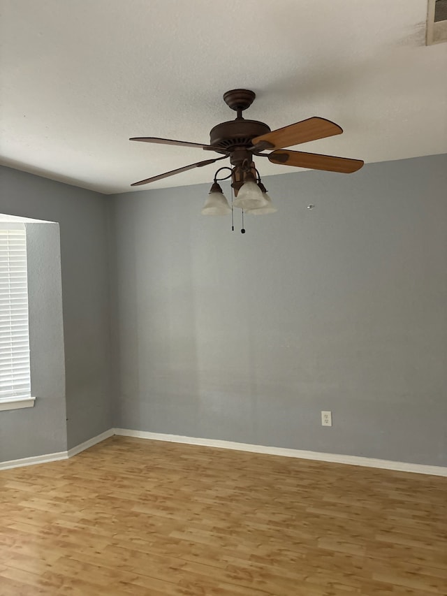 unfurnished room with hardwood / wood-style floors and ceiling fan