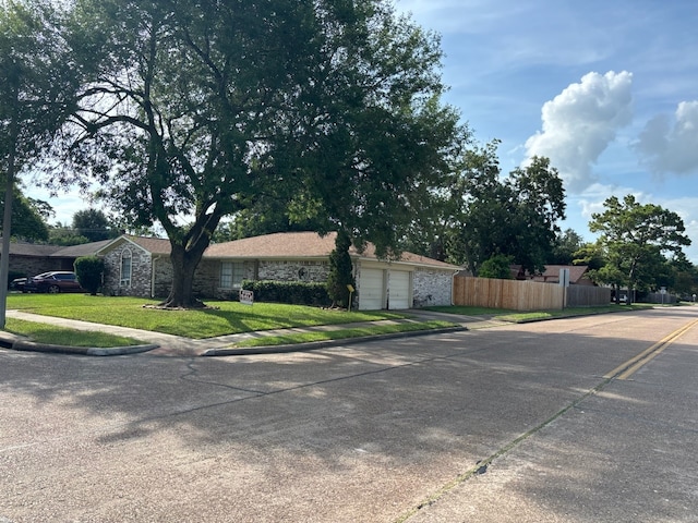 view of side of property featuring a lawn and a garage