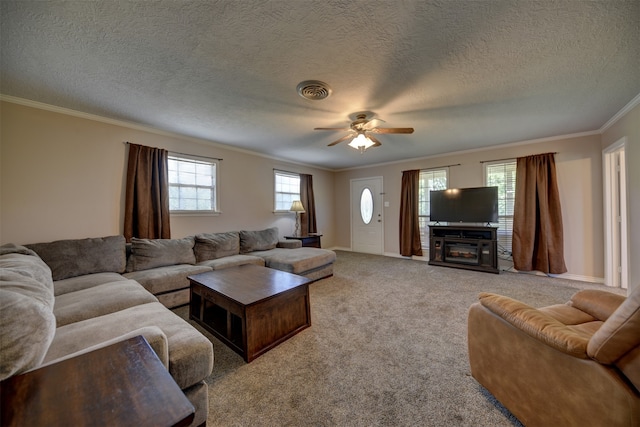 living room featuring ceiling fan, crown molding, carpet, and a textured ceiling