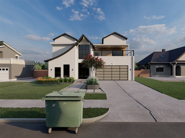 view of front facade with a balcony, a front yard, and a garage