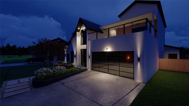 contemporary house featuring a yard and a garage