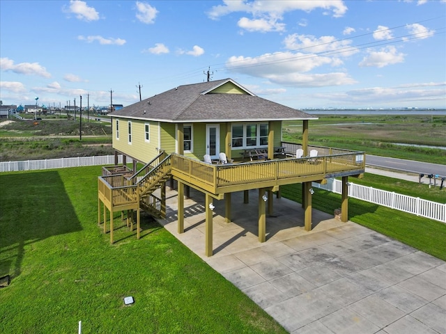 rear view of property featuring a lawn