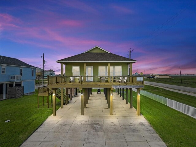 119 Velasco Shores Dr, Surfside Beach, TX 77541 - coastal inspired home with a carport, concrete driveway, roof with shingles, and a front yard
