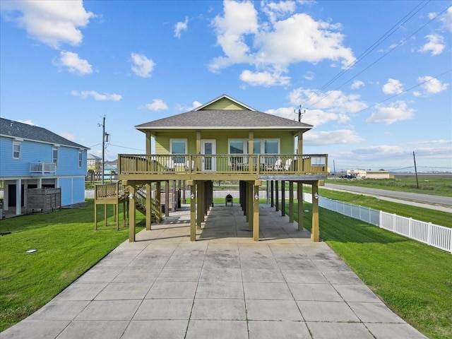 119 Velasco Shores Dr, Surfside Beach, TX 77541 - view of front of house with a carport, concrete driveway, a front lawn, and a shingled roof