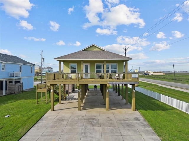 119 Velasco Shores Dr, Surfside Beach, TX 77541 - view of front of house with concrete driveway, a carport, roof with shingles, and covered porch