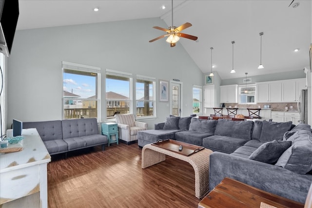 living room featuring plenty of natural light, high vaulted ceiling, wood-type flooring, and ceiling fan