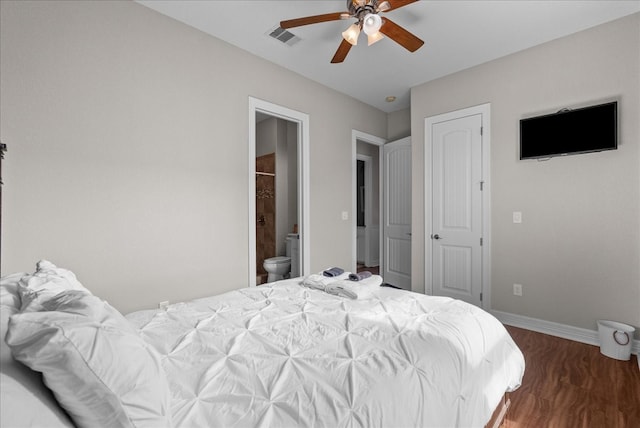 bedroom featuring ceiling fan, dark hardwood / wood-style floors, and connected bathroom