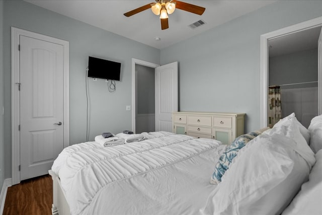 bedroom with dark hardwood / wood-style flooring and ceiling fan