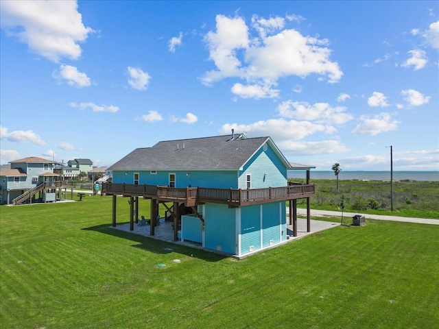 exterior space with a lawn and a deck with water view