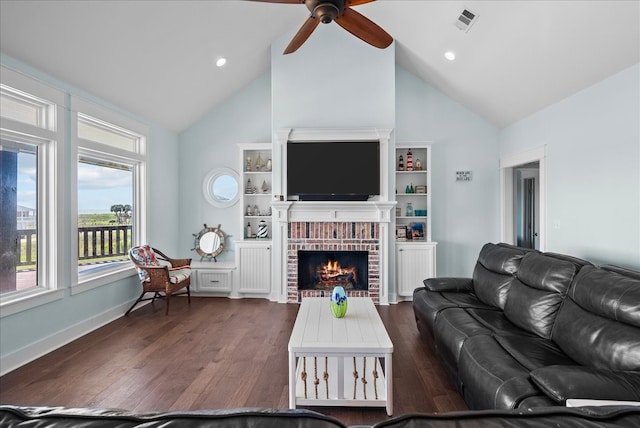 living room with high vaulted ceiling, built in shelves, dark hardwood / wood-style flooring, a brick fireplace, and ceiling fan