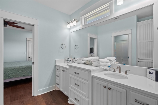 bathroom with vanity, wood-type flooring, an enclosed shower, and ceiling fan