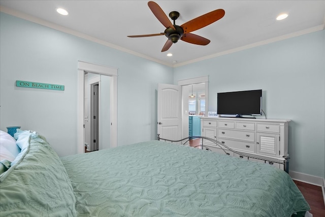 bedroom with crown molding, dark hardwood / wood-style flooring, and ceiling fan