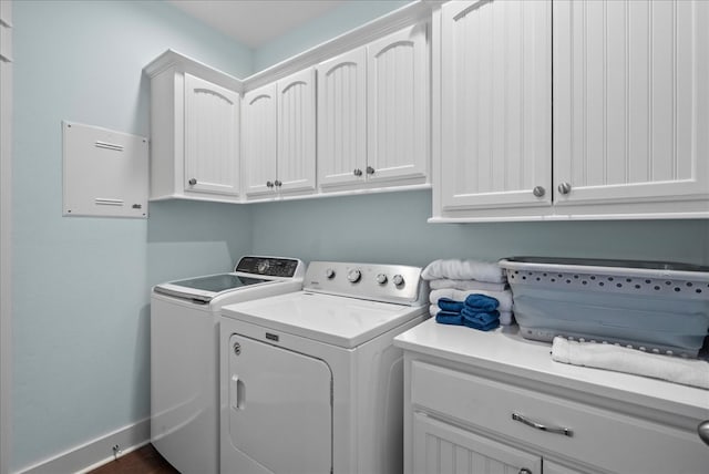 washroom with cabinets and washer and dryer