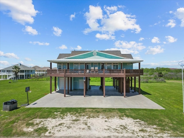 back of property with a garage, a lawn, and a patio