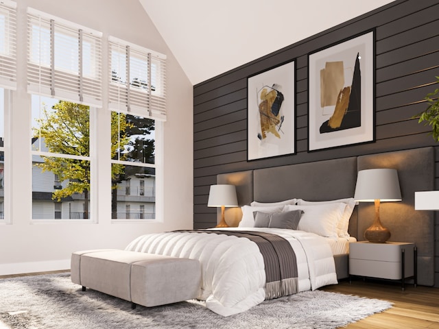 bedroom with hardwood / wood-style floors and vaulted ceiling