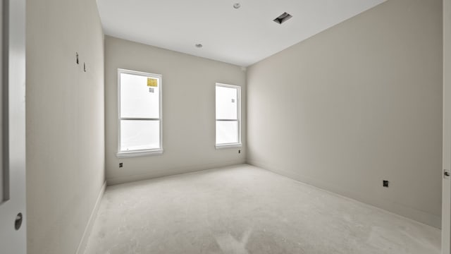 unfurnished room featuring light colored carpet