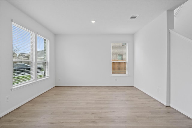 empty room with baseboards, visible vents, recessed lighting, and light wood-style floors