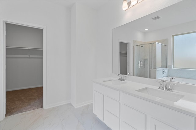 full bathroom featuring a spacious closet, a sink, visible vents, and a stall shower