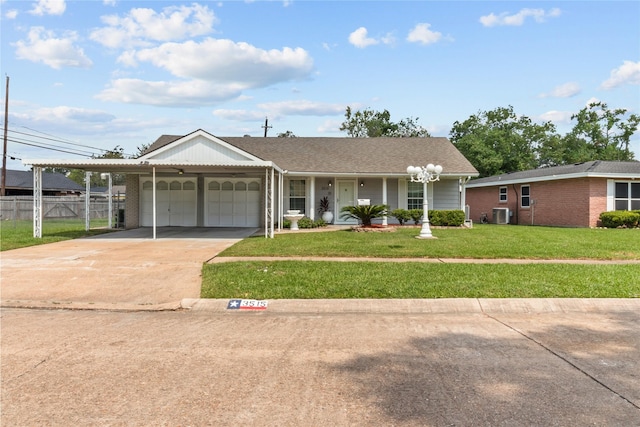 view of front of house with a front yard, a garage, a carport, and cooling unit