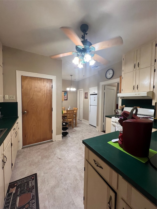 kitchen featuring ceiling fan, light tile patterned floors, white appliances, and decorative light fixtures