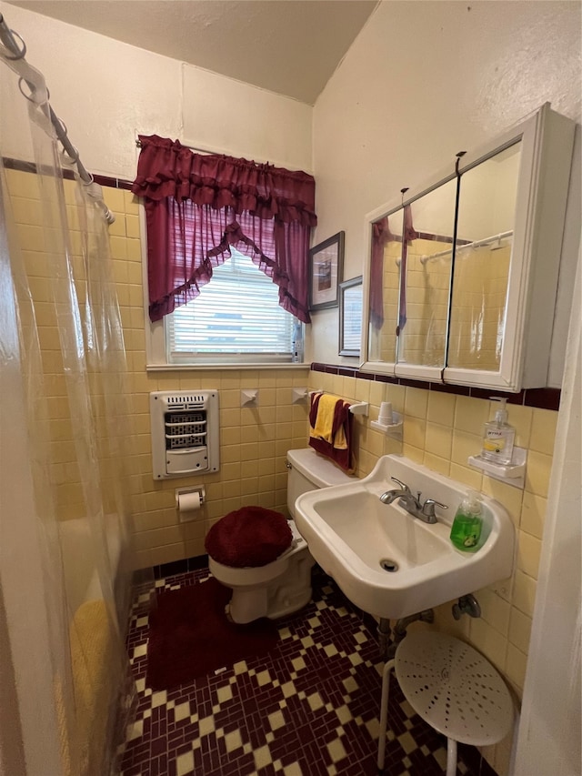 bathroom featuring toilet, tile patterned floors, heating unit, tile walls, and a shower with curtain