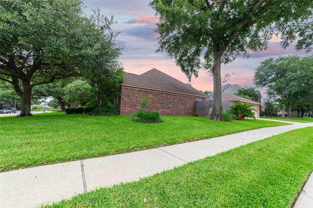 view of front of house with brick siding and a front lawn