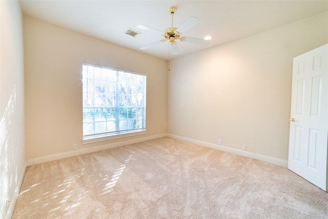 spare room featuring a ceiling fan, baseboards, visible vents, and carpet flooring